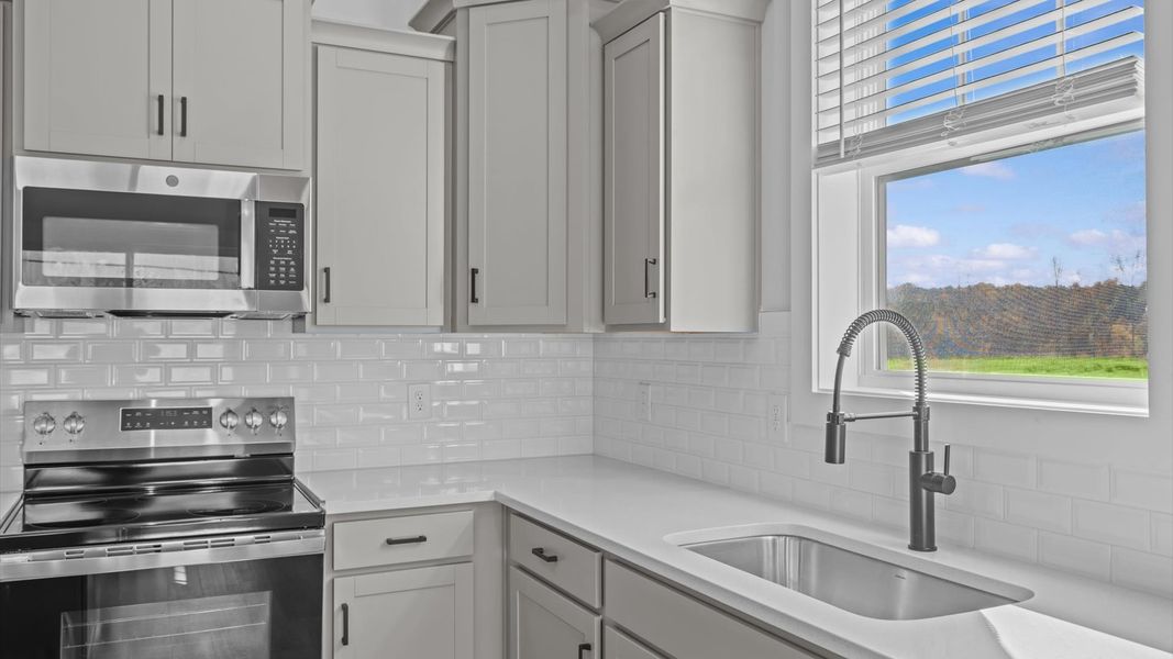 First-class finishes and a thoughtfully scaled island highlight this elegant kitchen space