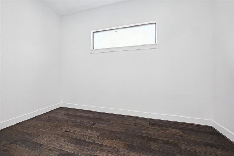 A well-appointed room adjoining the primary suite can serve as a home office, workout area, or quiet retreat, perfectly complementing the main bedroom.