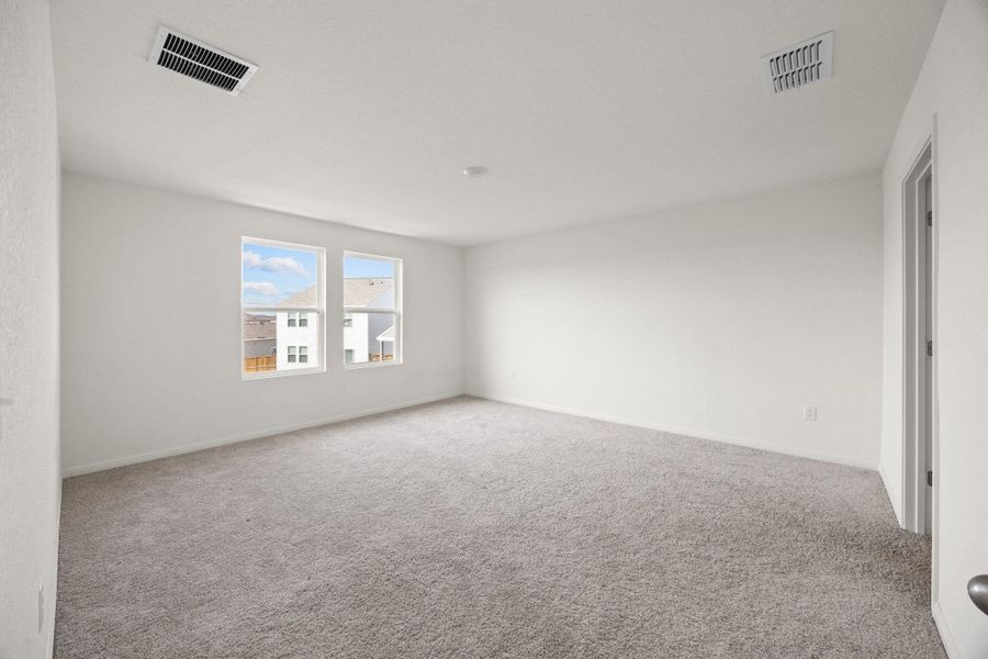 Carpeted spare room with baseboards