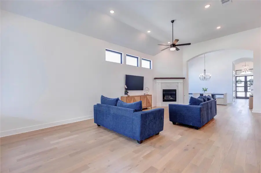 This modern kitchen features a spacious layout with sleek white cabinetry, warm wood accents, and a large island with pendant lighting. It includes stainless steel appliances, a gas cooktop, and ample counter space, perfect for cooking and entertaining. Large windows provide plenty of natural light. This modern kitchen features a spacious layout with sleek white cabinetry, warm wood accents, and a large island with pendant lighting. It includes stainless steel appliances, a gas cooktop, and ample counter space, perfect for cooking and entertaining. Large windows provide plenty of natural light.
