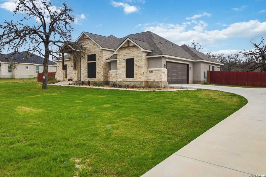 Front exterior of a new home in , La Vernia, TX, highlighting curb appeal (Image 24).