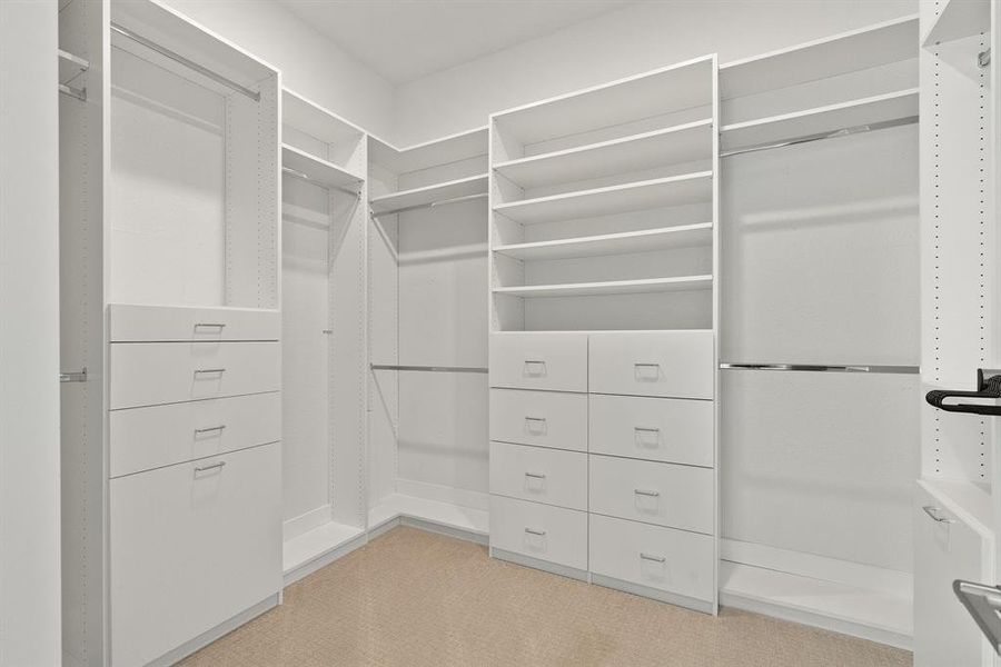 Primary Closet Featuring custom built ins.