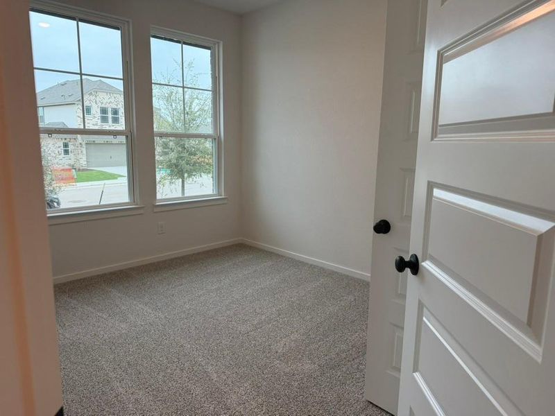 Spare room featuring light carpet and baseboards