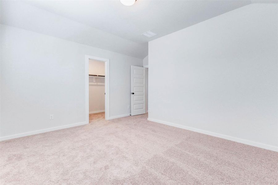 This view highlights the walk-in closet off one of the upstairs bedrooms, providing great storage and organization potential. With plenty of hanging space and shelving, it’s both practical and spacious.