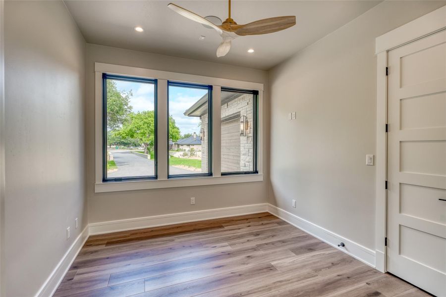 Empty room featuring a ceiling fan, light wood-type flooring, baseboards, and recessed lighting