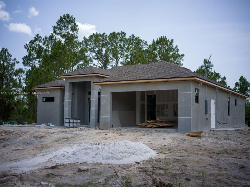 Front exterior of a new home in , Lehigh Acres, FL, highlighting curb appeal (Image 23).