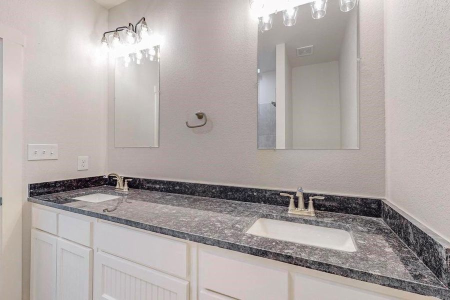 Bathroom featuring double vanity