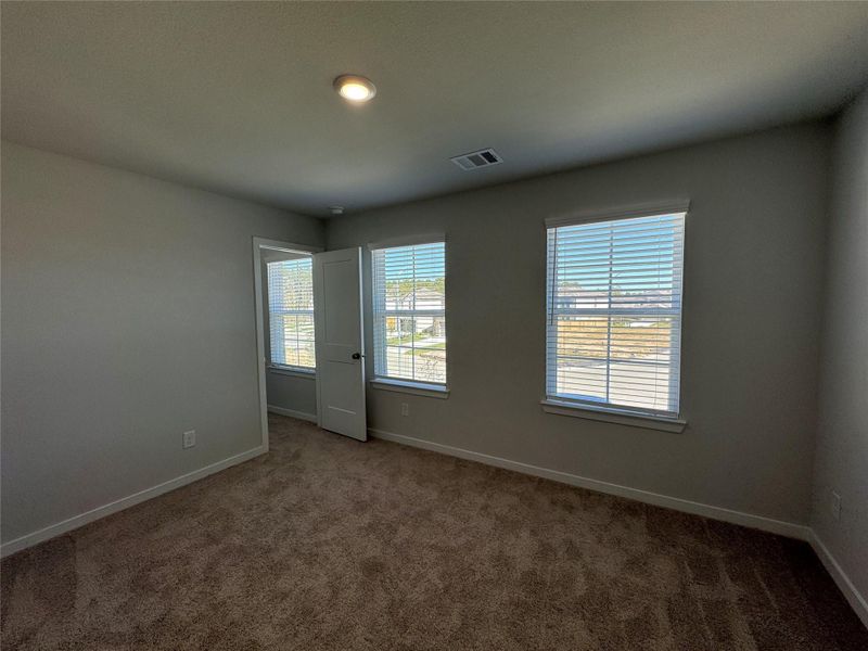 Large upstairs bedroom facing the front of the home with a walk-in closet. Large upstairs bedroom facing the front of the home with a walk-in closet.
