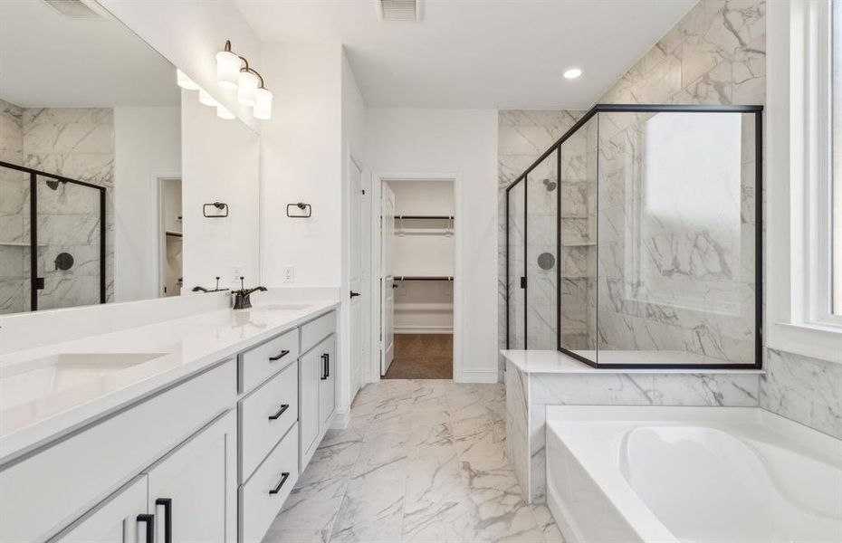 Elegant owner's bathroom with dual vanity *real home pictured