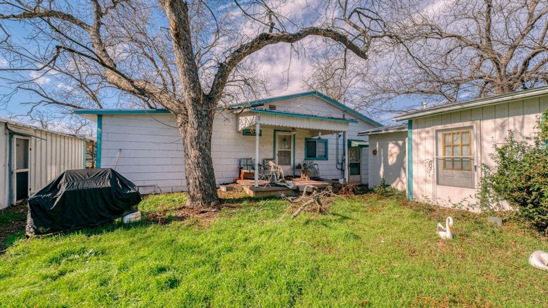 Rear view of house with a lawn