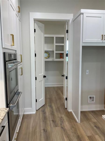 Kitchen heading into custom walk in pantry