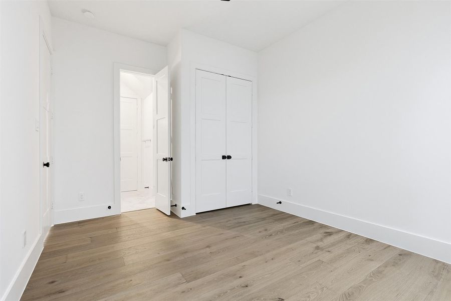 The secondary bedroom includes a double-door closet and direct access to a private ensuite bathroom.