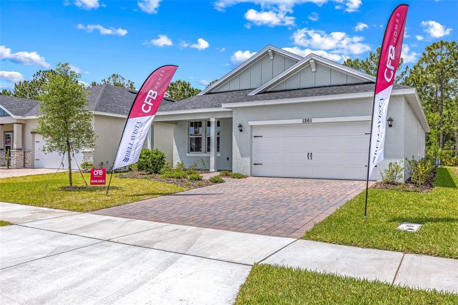 Front exterior of a new home in Gray Hawk at Hole Two, Daytona Beach, FL, highlighting curb appeal (Image 1). Front exterior of a new home in Gray Hawk at Hole Two, Daytona Beach, FL, highlighting curb appeal (Image 1).