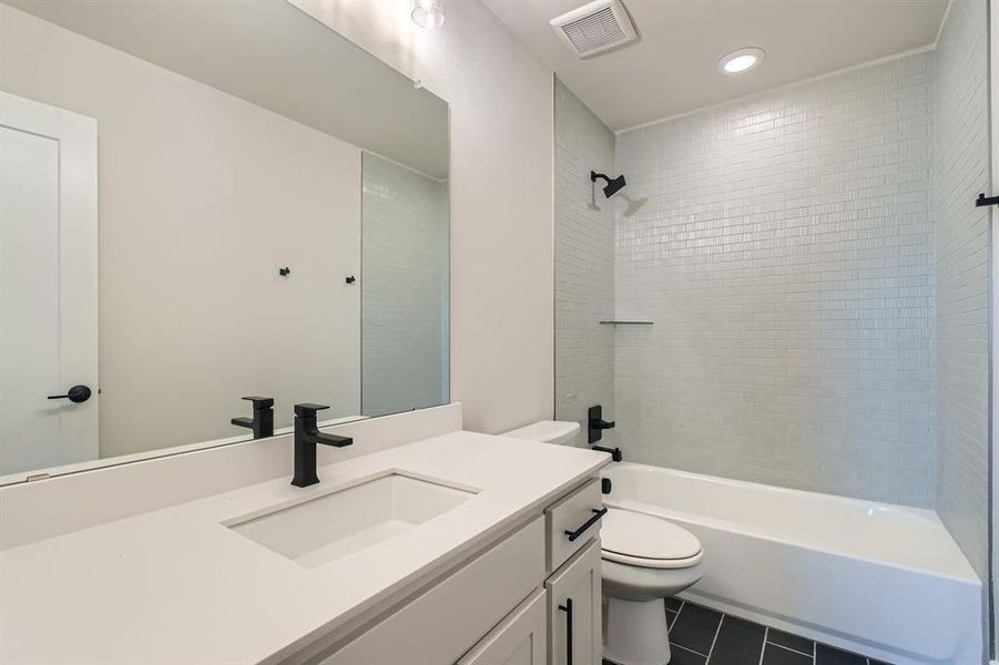 Full bathroom with tile patterned flooring, vanity, bathtub / shower combination, and recessed lighting Full bathroom with tile patterned flooring, vanity, bathtub / shower combination, and recessed lighting