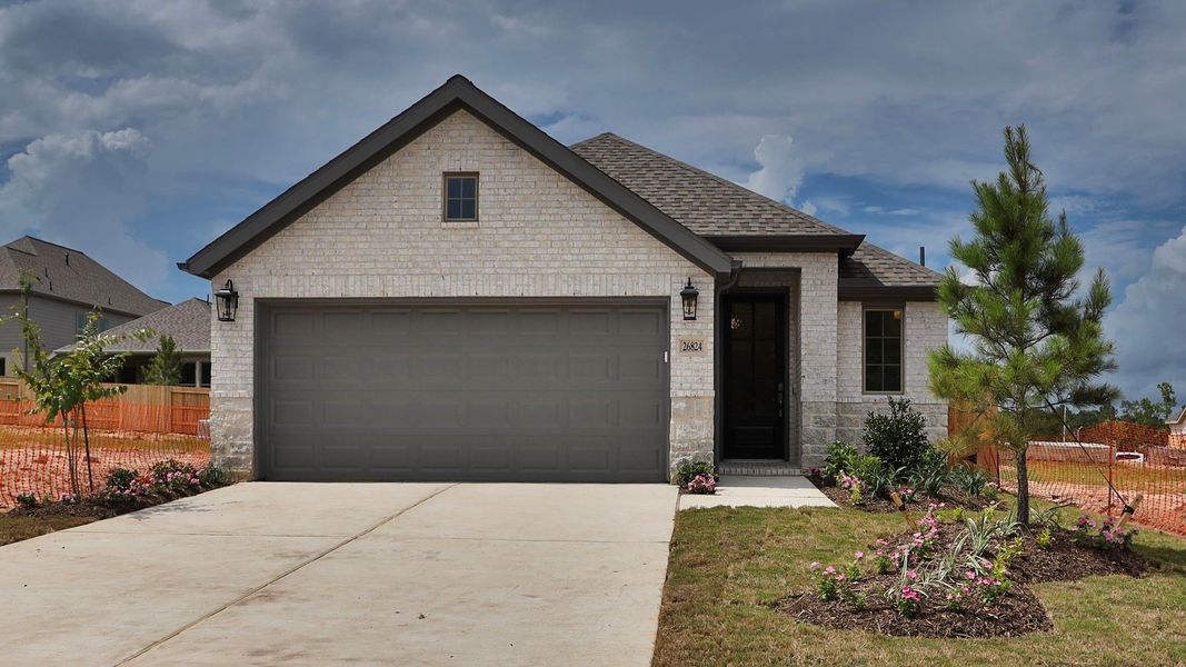Front exterior of a new home in Wildtree, Magnolia, TX, highlighting curb appeal (Image 1). Front exterior of a new home in Wildtree, Magnolia, TX, highlighting curb appeal (Image 1).