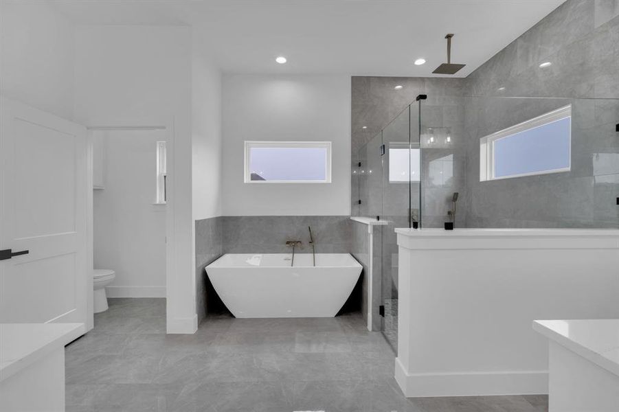 Full bathroom with toilet, tile patterned floors, vanity, and independent shower and bath