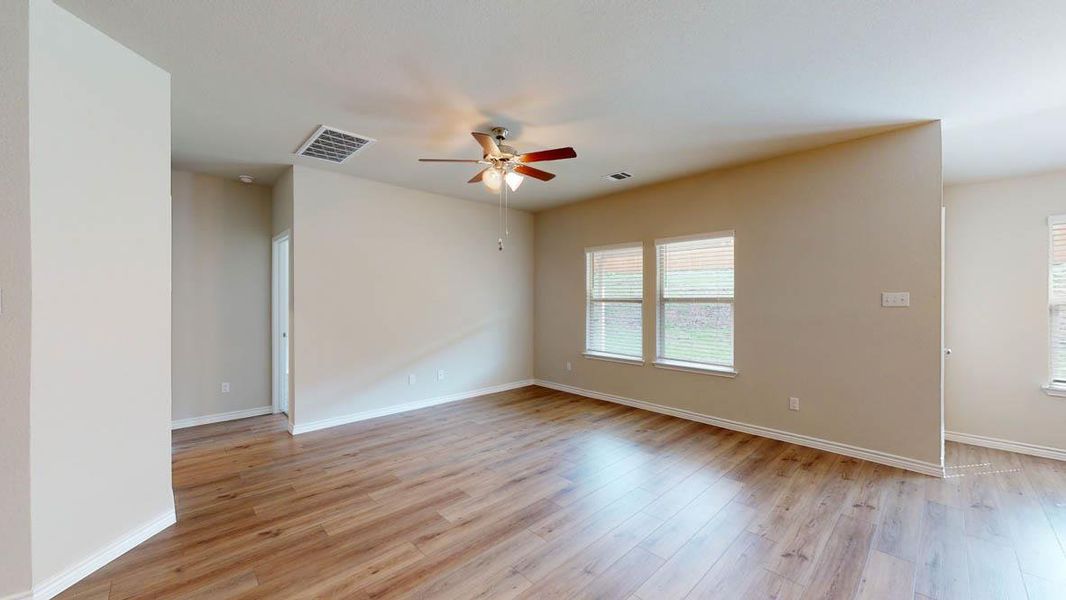Spare room featuring ceiling fan and light wood-type flooring