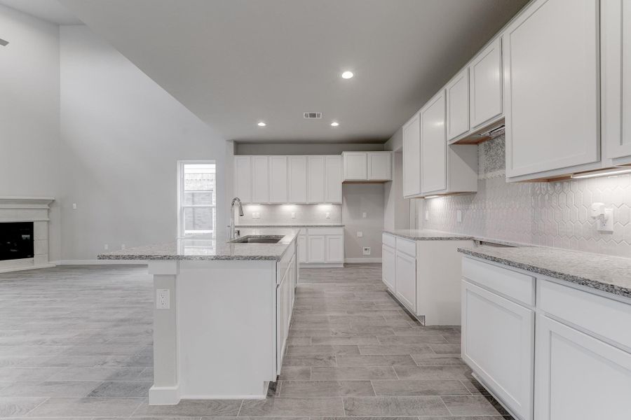 This generously spacious kitchen is a dream realized! Sample photo of completed home with similar floor plan. As-built interior colors and selections may vary.