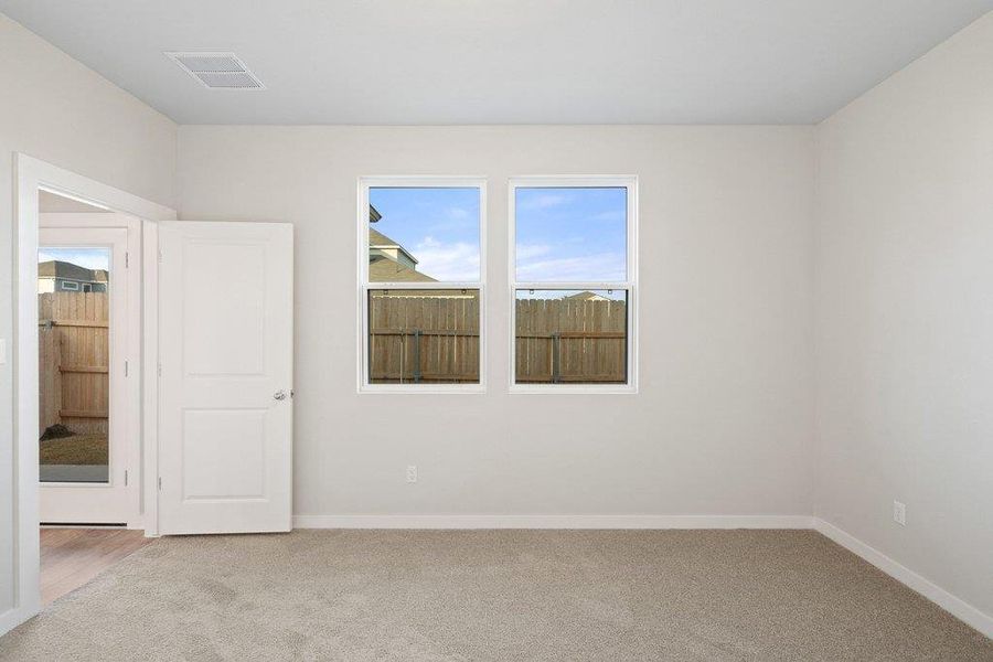 Unfurnished room featuring light colored carpet and baseboards