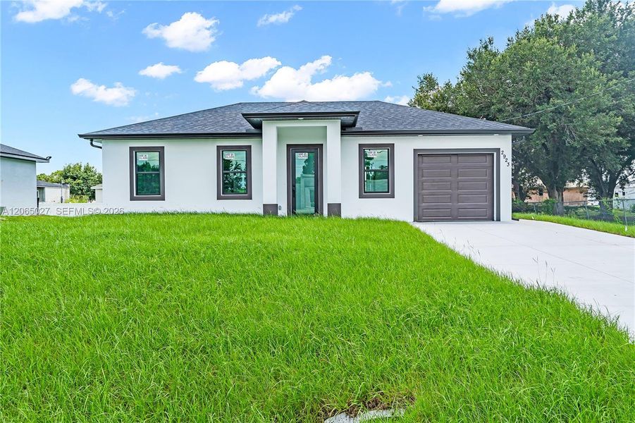 Front exterior of a new home in , Lehigh Acres, FL, highlighting curb appeal (Image 1). Front exterior of a new home in , Lehigh Acres, FL, highlighting curb appeal (Image 1).