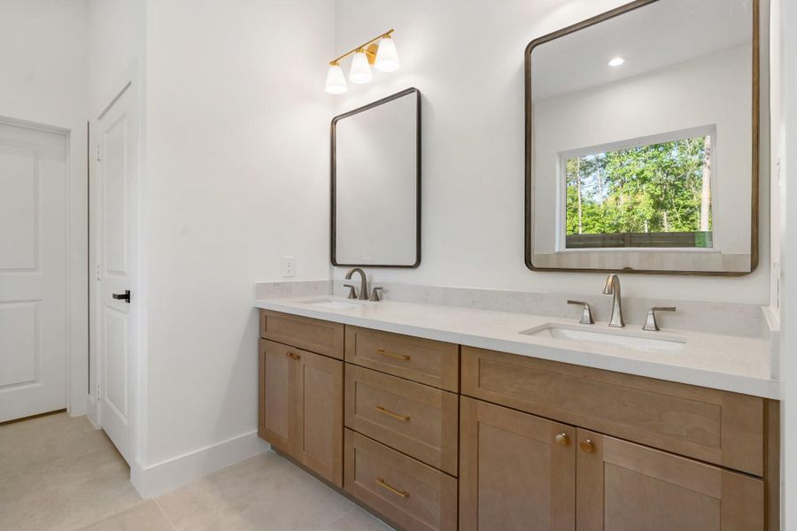 The elegant, spa-like primary bathroom boasts high-end finishes and a large walk-in closet. The elegant, spa-like primary bathroom boasts high-end finishes and a large walk-in closet.