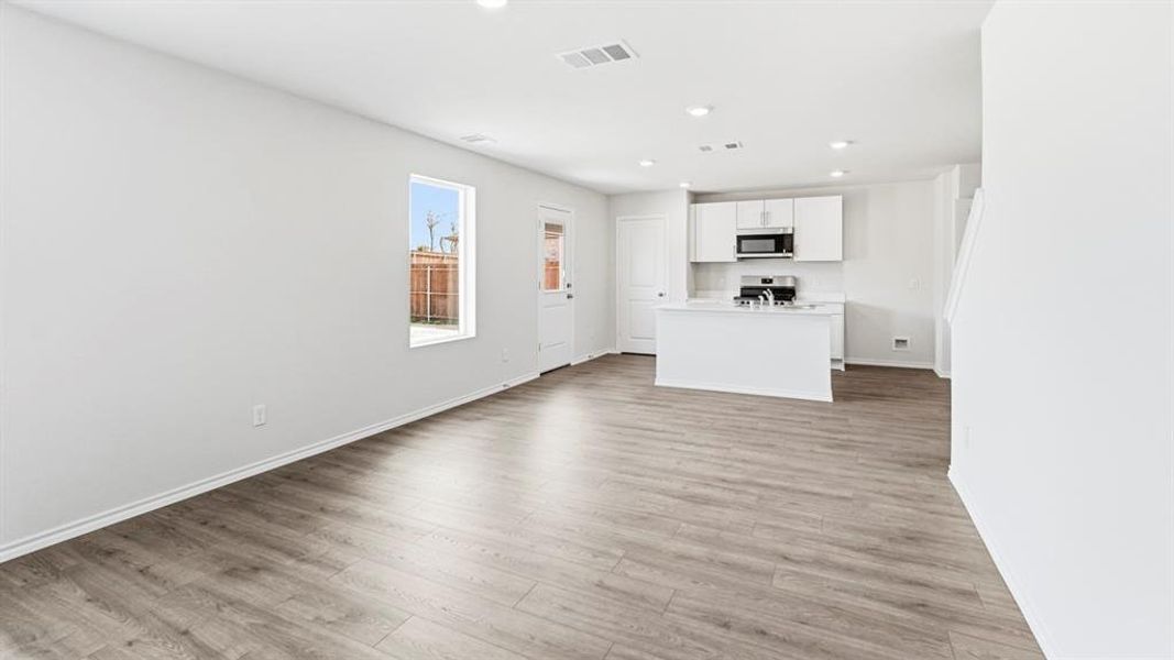 Unfurnished living room featuring recessed lighting and light wood-type flooring