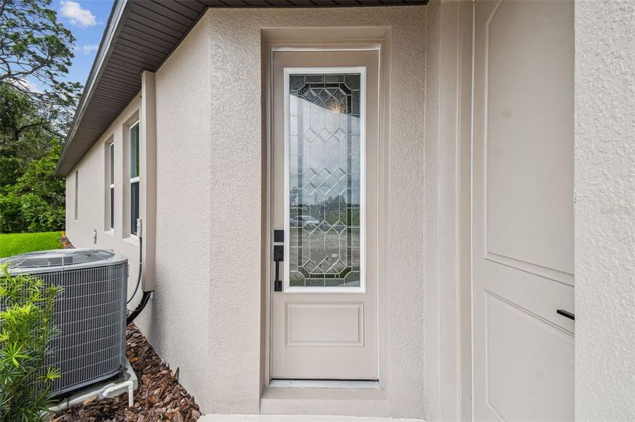Front exterior of a new home in Hidden Ridge, New Port Richey, FL, highlighting curb appeal (Image 26).