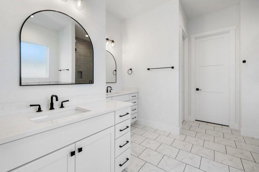 Full bath with double vanity and two vanities