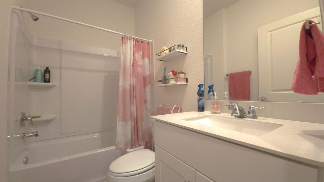 White vanity with an integrated sink and chrome faucet