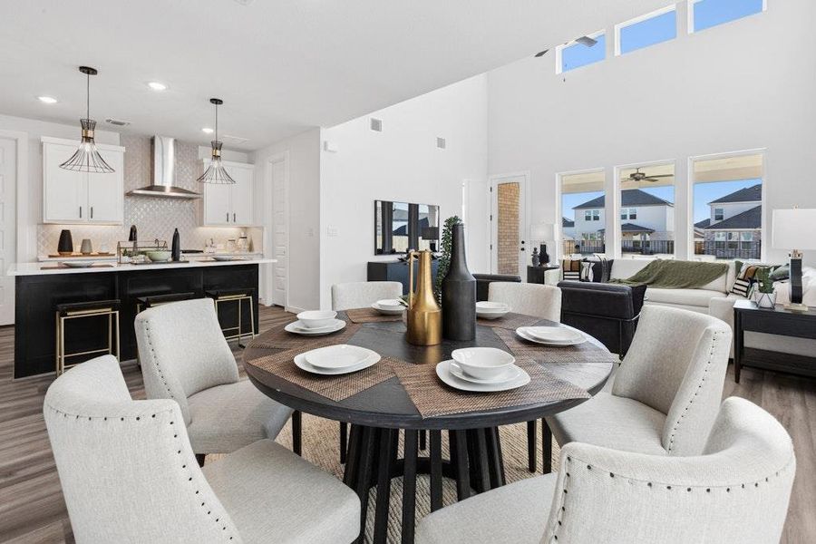 Dining space featuring wood finished floors, plenty of natural light, and recessed lighting Dining space featuring wood finished floors, plenty of natural light, and recessed lighting