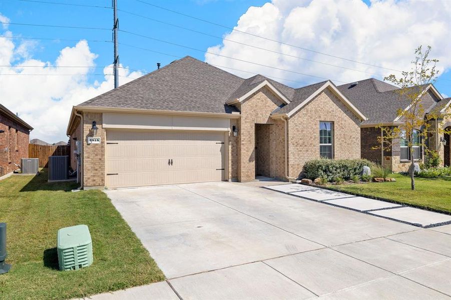 Ranch-style home with brick siding, a shingled roof, a front yard, and driveway Ranch-style home with brick siding, a shingled roof, a front yard, and driveway