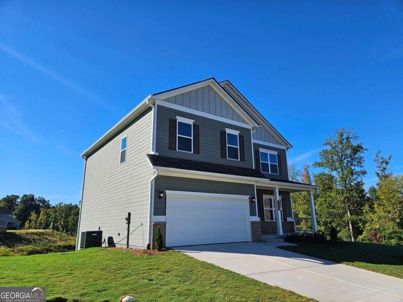 Front exterior of a new home in Maddox Station, Eatonton, GA, highlighting curb appeal (Image 21). Front exterior of a new home in Maddox Station, Eatonton, GA, highlighting curb appeal (Image 21).