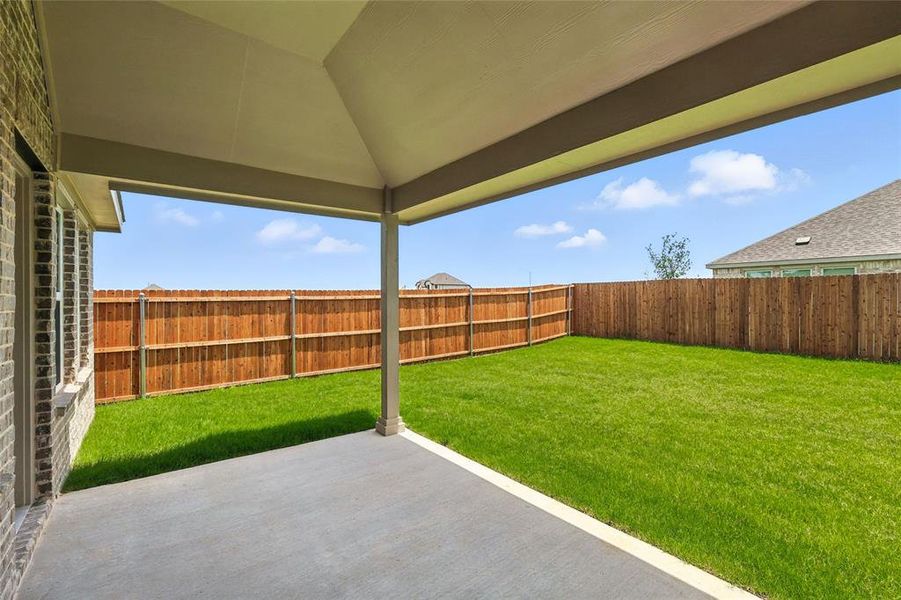 Fenced backyard with a patio