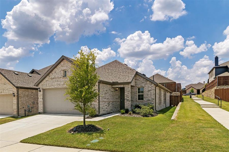 Brick exterior with a single-car garage and concrete driveway Brick exterior with a single-car garage and concrete driveway