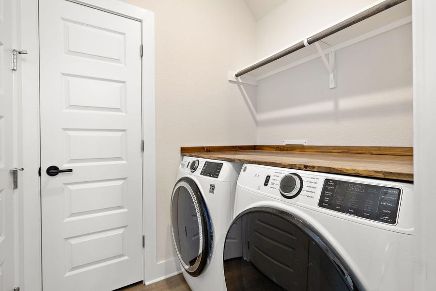 Laundry area with built-in folding table and washer and dryer (washer/dryer to convey in the sale)