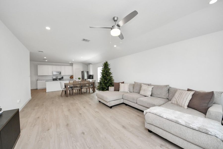 The livingrooom has ample space for large furniture and still leaves room for a large dining area.