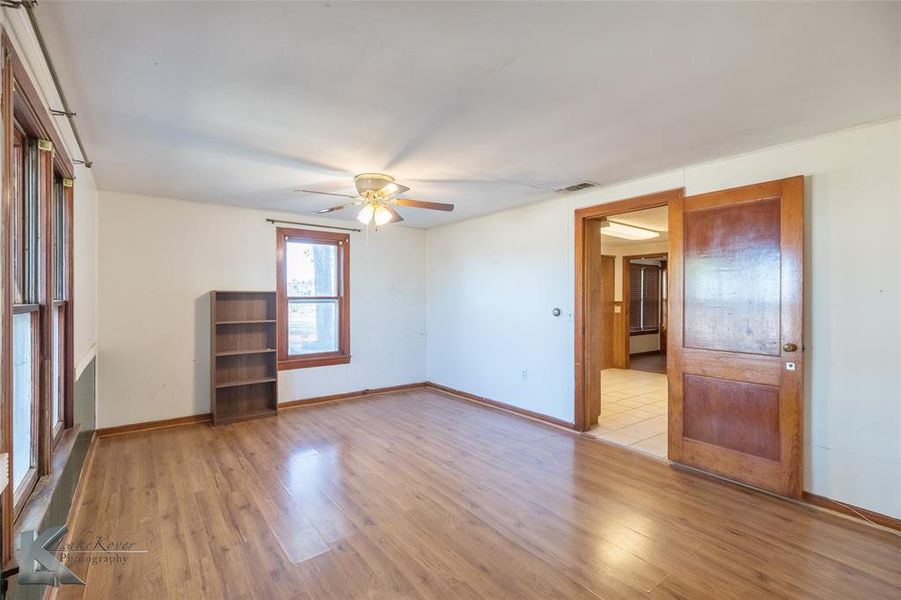 Spare room with light wood-style floors and a ceiling fan Spare room with light wood-style floors and a ceiling fan