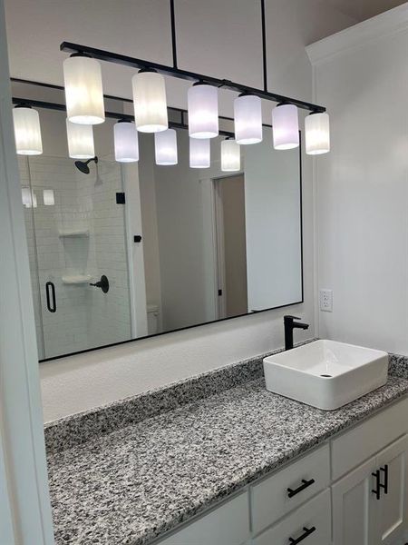 Full bath featuring vanity and a shower stall