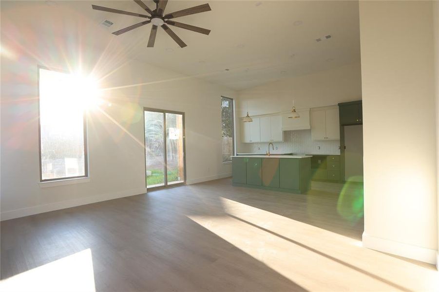 Unfurnished living room with wood finished floors and a ceiling fan Unfurnished living room with wood finished floors and a ceiling fan