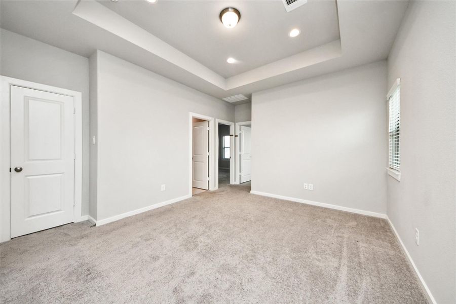 Expansive upstairs bonus room with neutral finishes and versatile functionality for a media room, playroom, or additional lounge space.