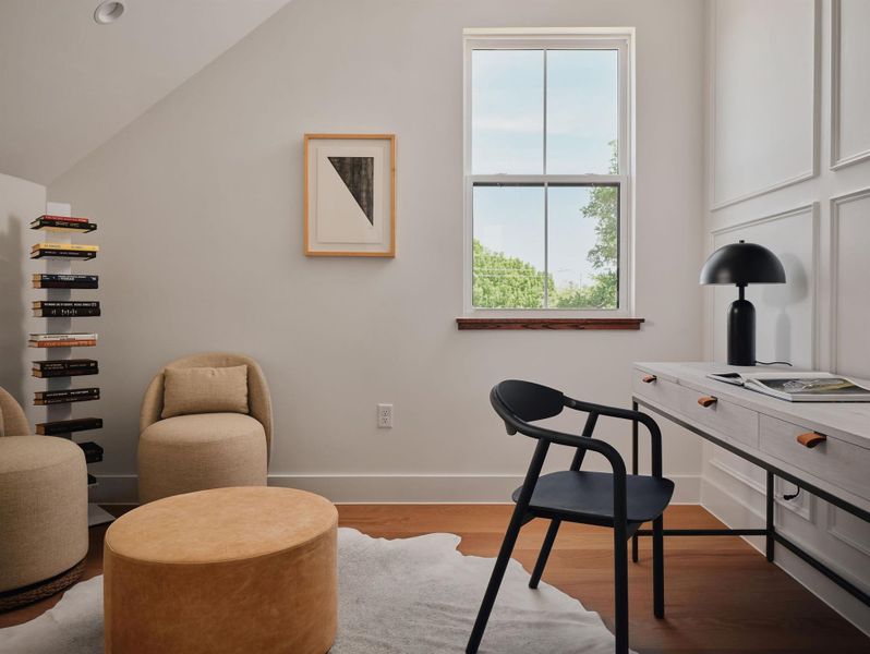Office area featuring wood finished floors and lofted ceiling