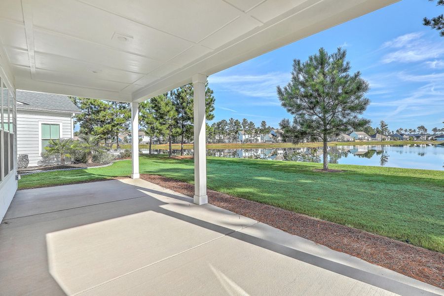 Exterior details and patio area of a home in K. Hovnanian's® Four Seasons at Lakes of Cane Bay, Summerville (Image 3).