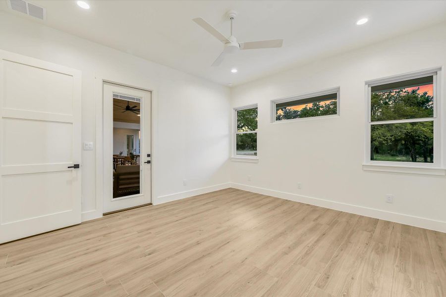 Empty room with light wood-style flooring, ceiling fan, and recessed lighting