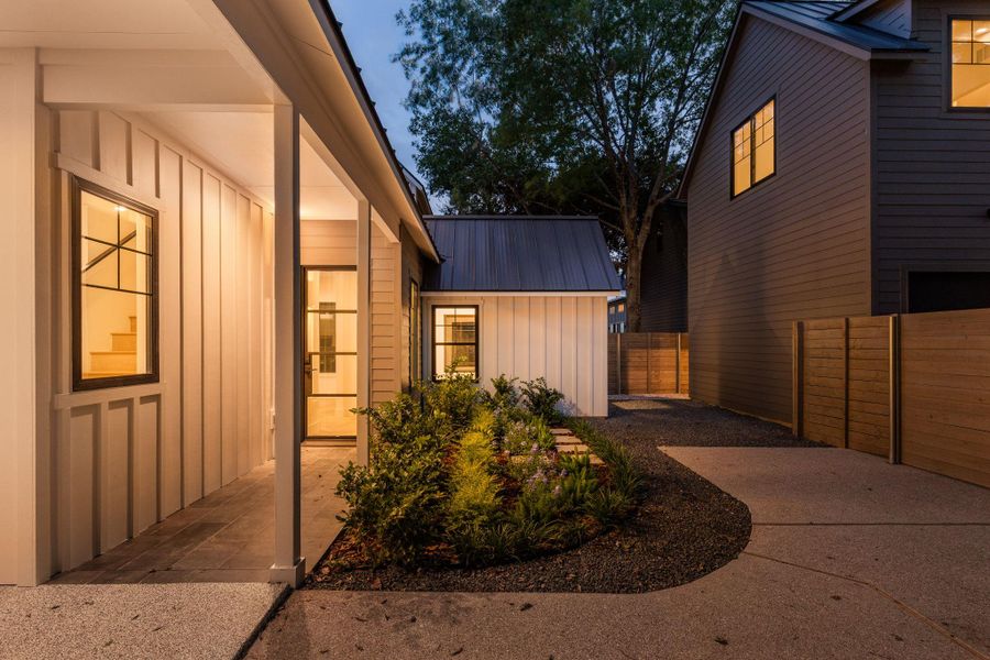 Property entrance with board and batten siding and a metal roof Property entrance with board and batten siding and a metal roof