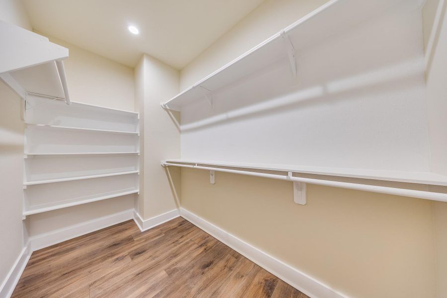 Spacious walk in closet with plenty of room to organize your wardrobe and accessories Spacious walk in closet with plenty of room to organize your wardrobe and accessories