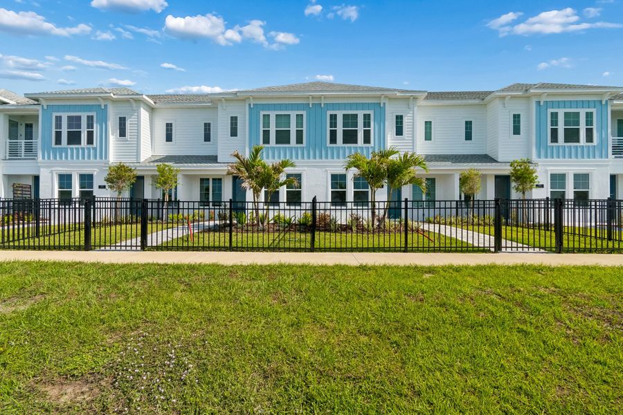 Front exterior of a new home in Emerald Landing at Waterside at Lakewood Ranch – Towns, Sarasota, FL, highlighting curb appeal (Image 2). Front exterior of a new home in Emerald Landing at Waterside at Lakewood Ranch – Towns, Sarasota, FL, highlighting curb appeal (Image 2).