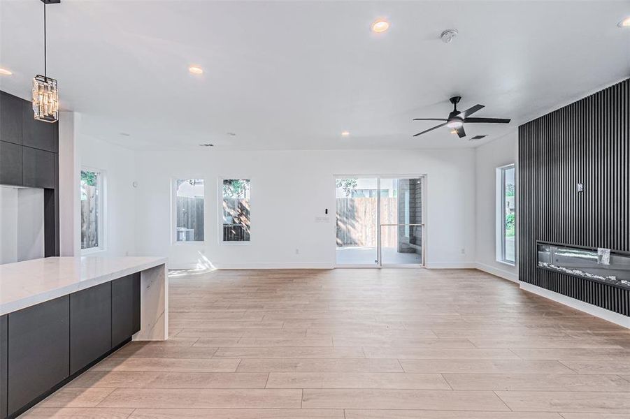 Unfurnished living room with recessed lighting, a fireplace, light wood-style floors, and ceiling fan