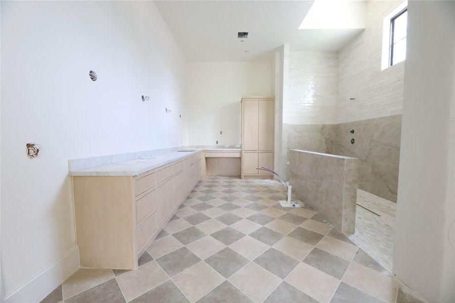 Primary Bathroom offers custom site-built dual vanity w/ linen built-in and extra large walk-in shower & soak tub.