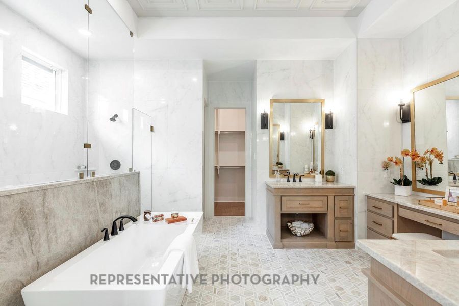Bathroom featuring walk in shower, a soaking tub, vanity, and tile walls Bathroom featuring walk in shower, a soaking tub, vanity, and tile walls