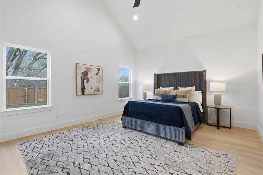 Bedroom featuring light wood-type flooring, ceiling fan, lofted ceiling, and recessed lighting Bedroom featuring light wood-type flooring, ceiling fan, lofted ceiling, and recessed lighting